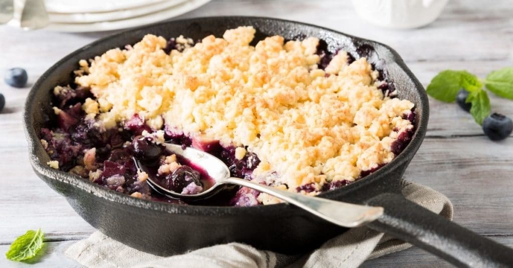 Blueberry Crumble Dessert in an iron pan