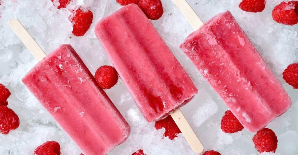 Frozen popsicles frozen from a smoothie with raspberries around them, How to Make a Healthy Smoothie