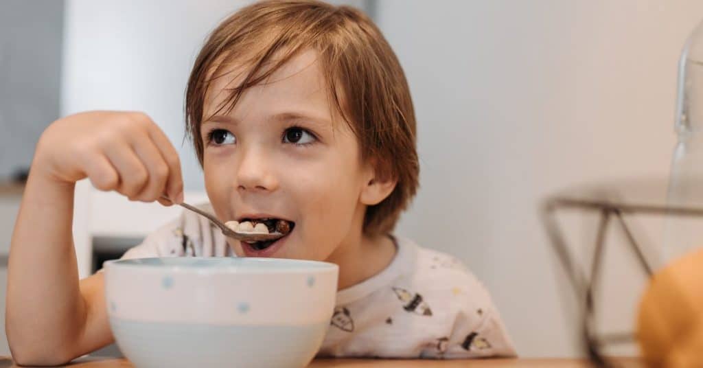 A little boy eats a spoonful of sugary cereal, Understanding Your Picky Eater Toddler