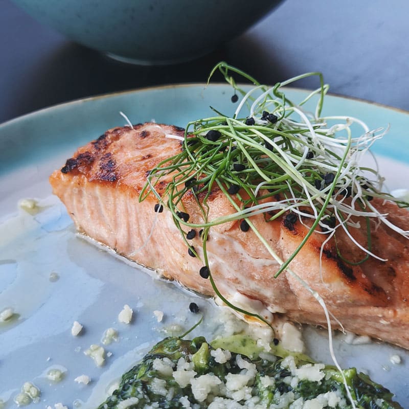 Salmon topped with sprouts, anti-inflammatory customized meal plan