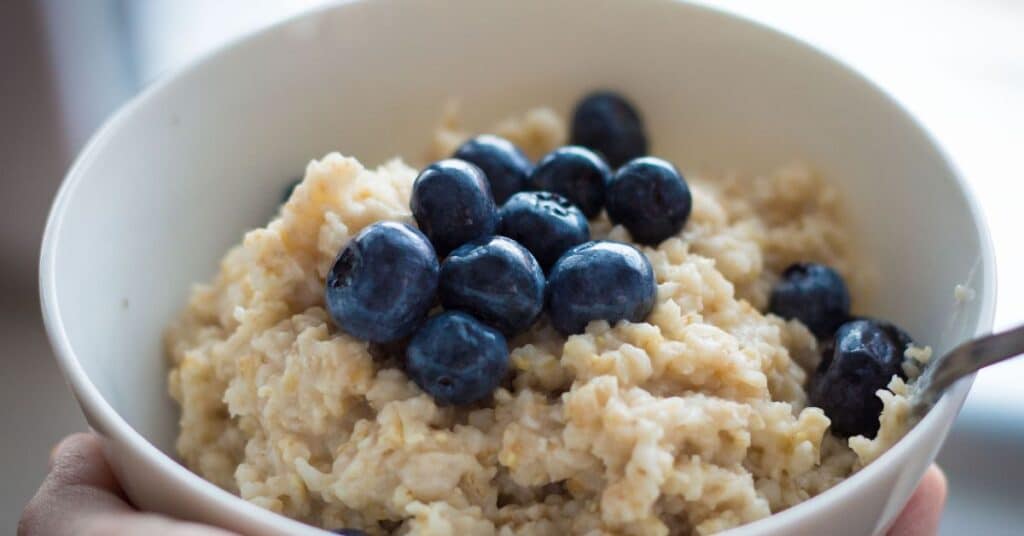 A bowl of oats topped with blueberries