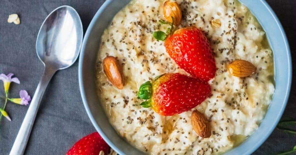 A bowl of oats topped with chia seeds, almonds, and strawberries, Are carbohydrates good for you