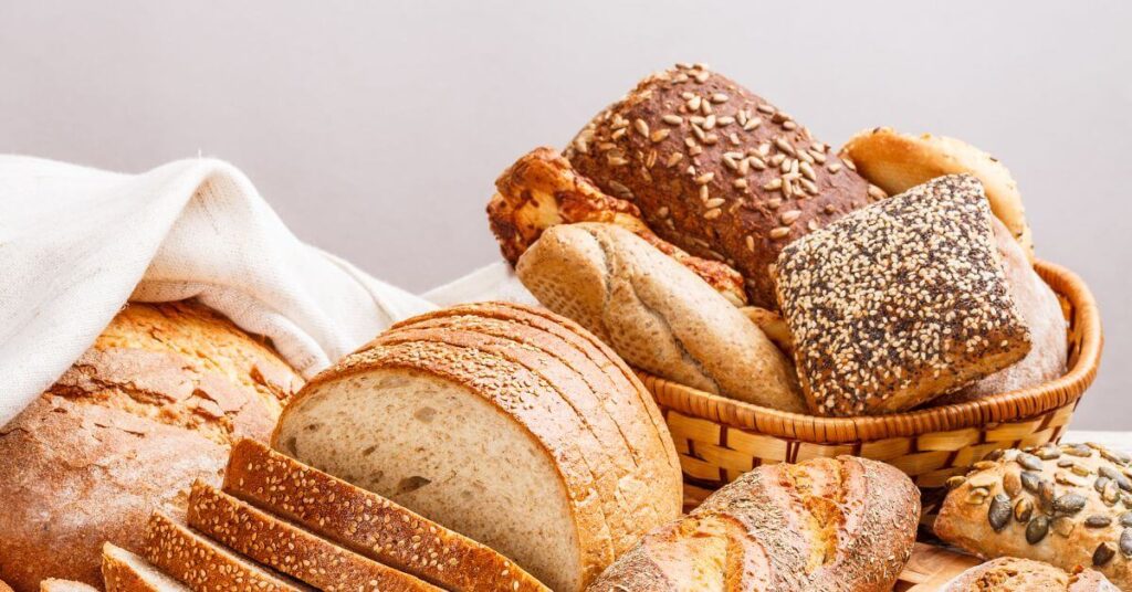 Various breads displayed on a table, what is gluten