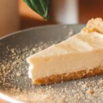 A slice of cheese cake with a graham cracker crumb crust, Gluten Free Holiday Dessert Recipes