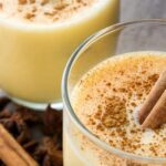 Fresh eggnog topped with a sprinkle of cinnamon and a cinnamon stick, Gluten Free Holiday Dessert Recipes