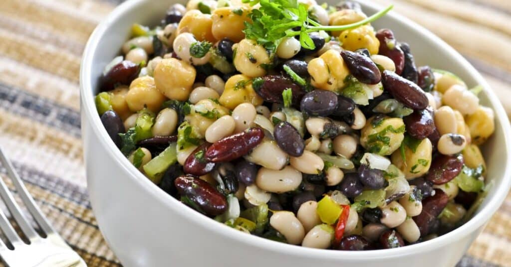 Bowl of fresh legumes, herbs and veggies tossed in olive oil, Low Glycemic Diet Benefits