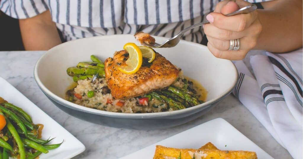 Salmon, asparagus and rice in a bowl on a table