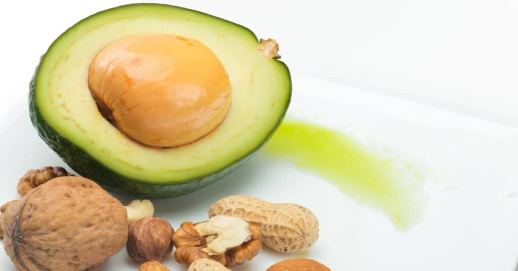 High fat avocado and mixed nuts on a white table, keto diet advantages and disadvantages