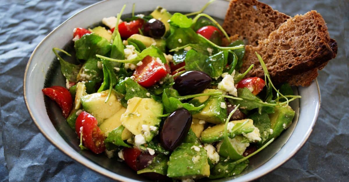 Arugala Salad with olives, tomatoes and avocado, seasonal foods